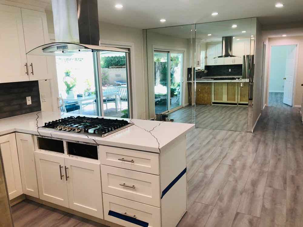 An open-plan kitchen and hallway cleaned throughout, with clear counters and mopped floors