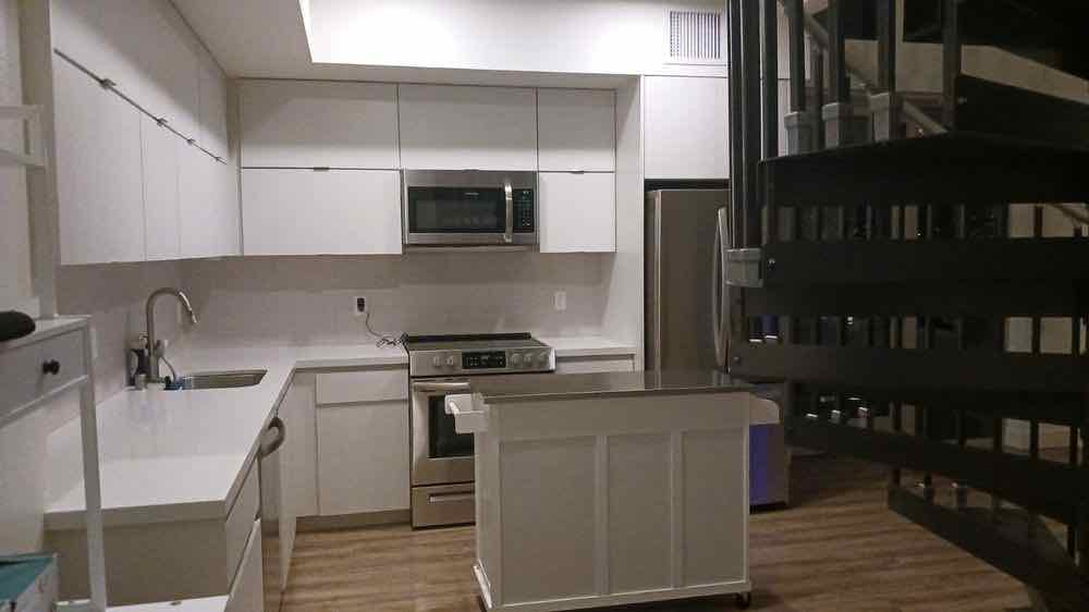 An empty white kitchen wiped down and cleaned ready for a new tenant